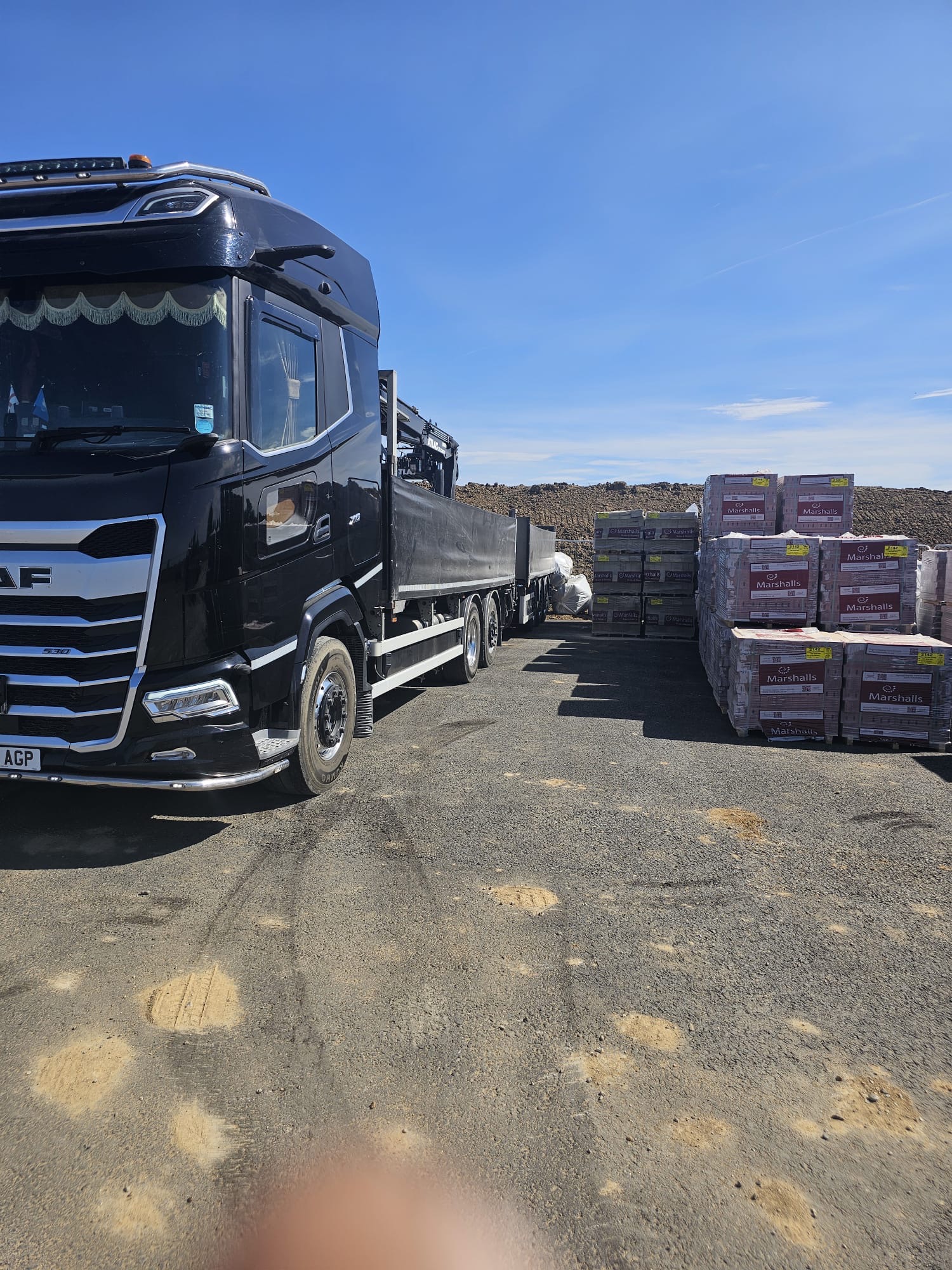 AGP DAF crane lorry at a builders merchant yard